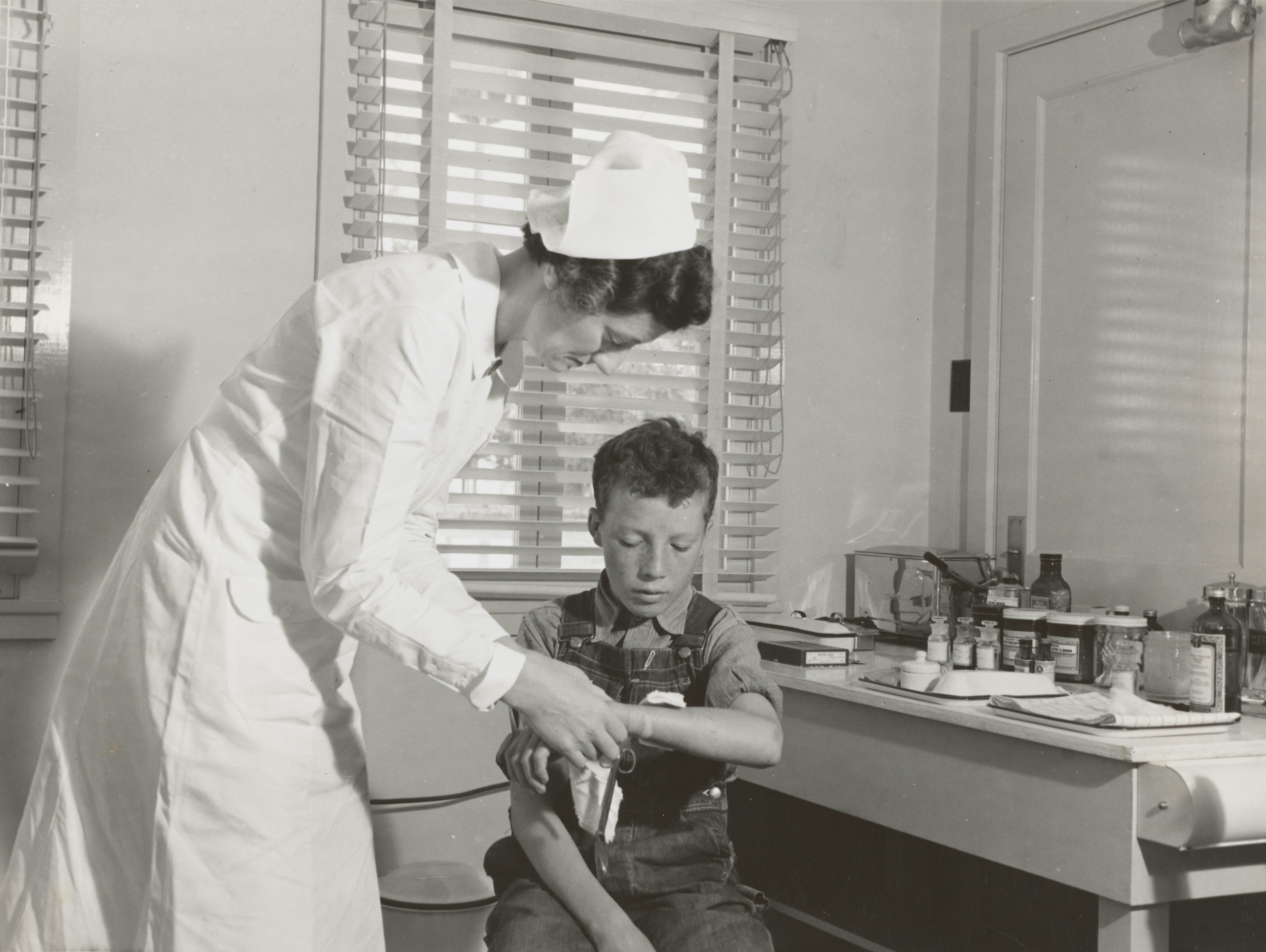 Nurse bandaging boy