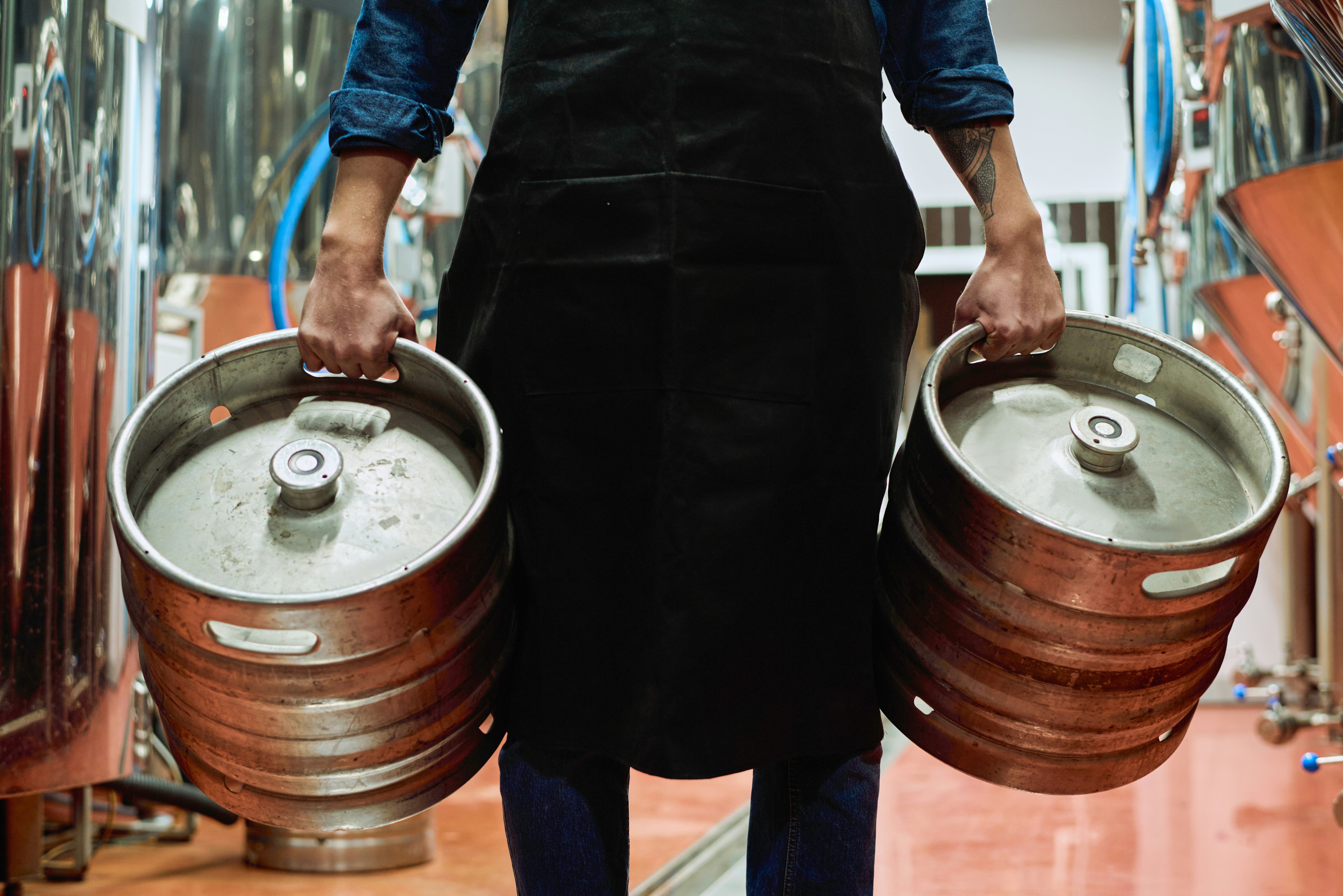 Man carrying two kegs