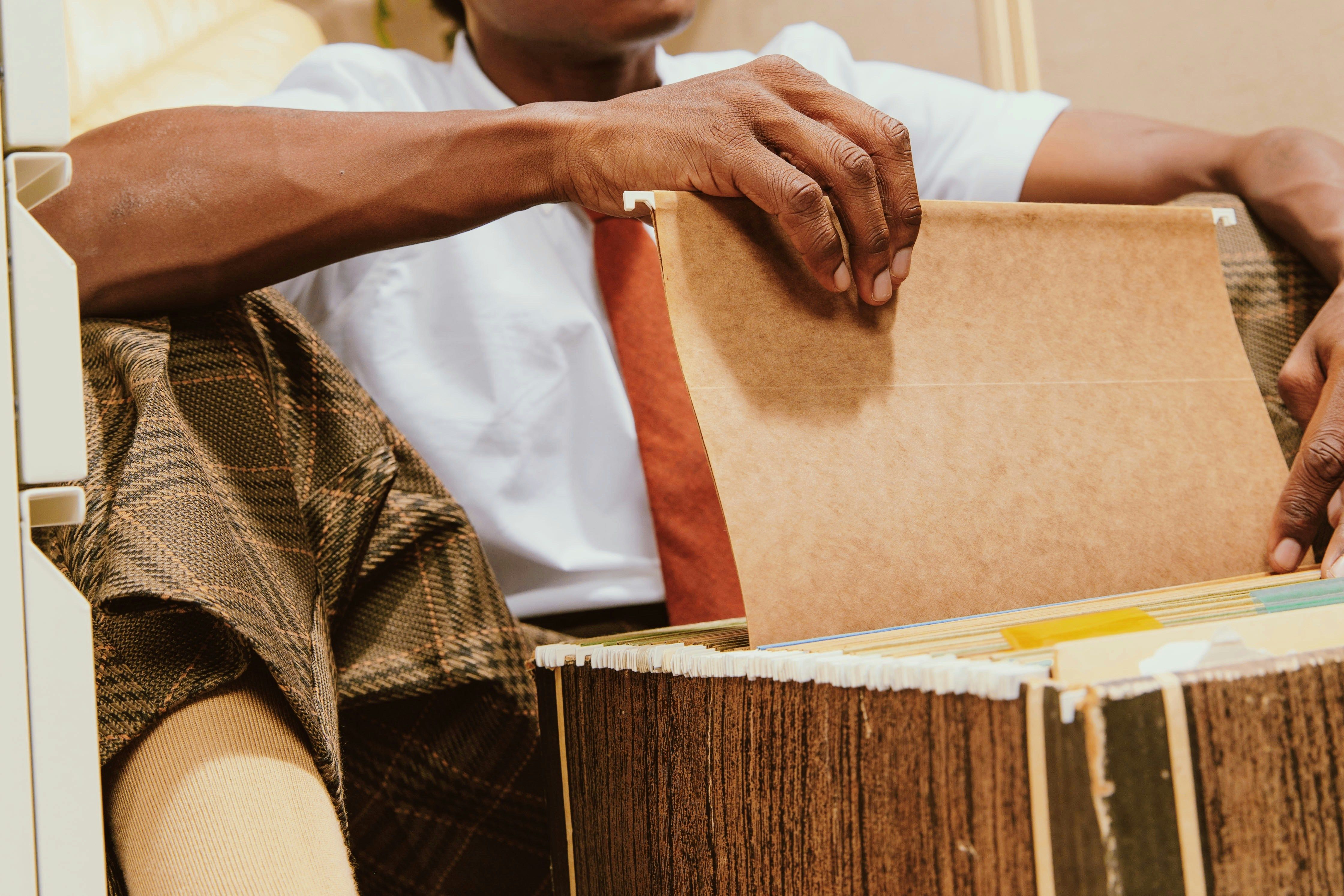 Man pulling file from file cabinet